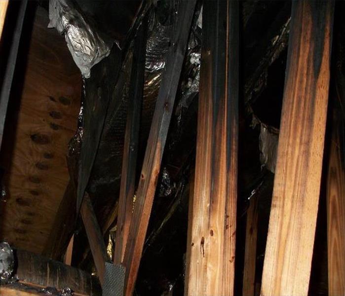 blackened rafters in an attic, ceiling removed