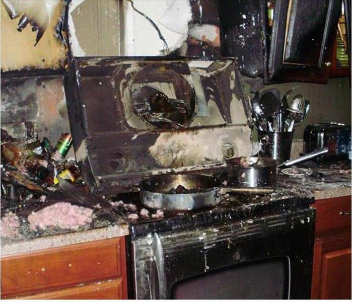 scorched and burned kitchen range and cabinets