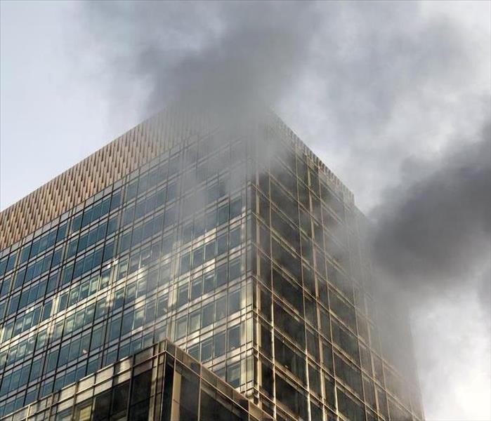 Smoke flowing out of a commercial high-rise. 